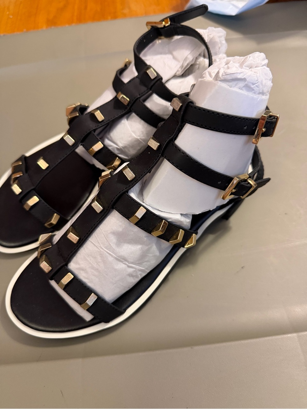 Cole Haan Black Gladiator Sandals with Gold Accents